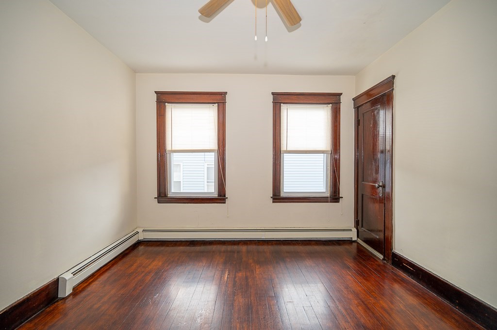 19 Fifth Avenue Worcester, MA 01607 - Photo 18 of 42 an empty room with wooden floor and windows