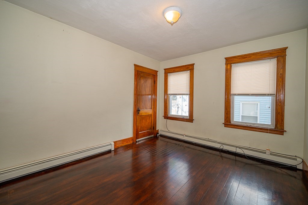 19 Fifth Avenue Worcester, MA 01607 - Photo 23 of 42 an empty room with wooden floor and windows