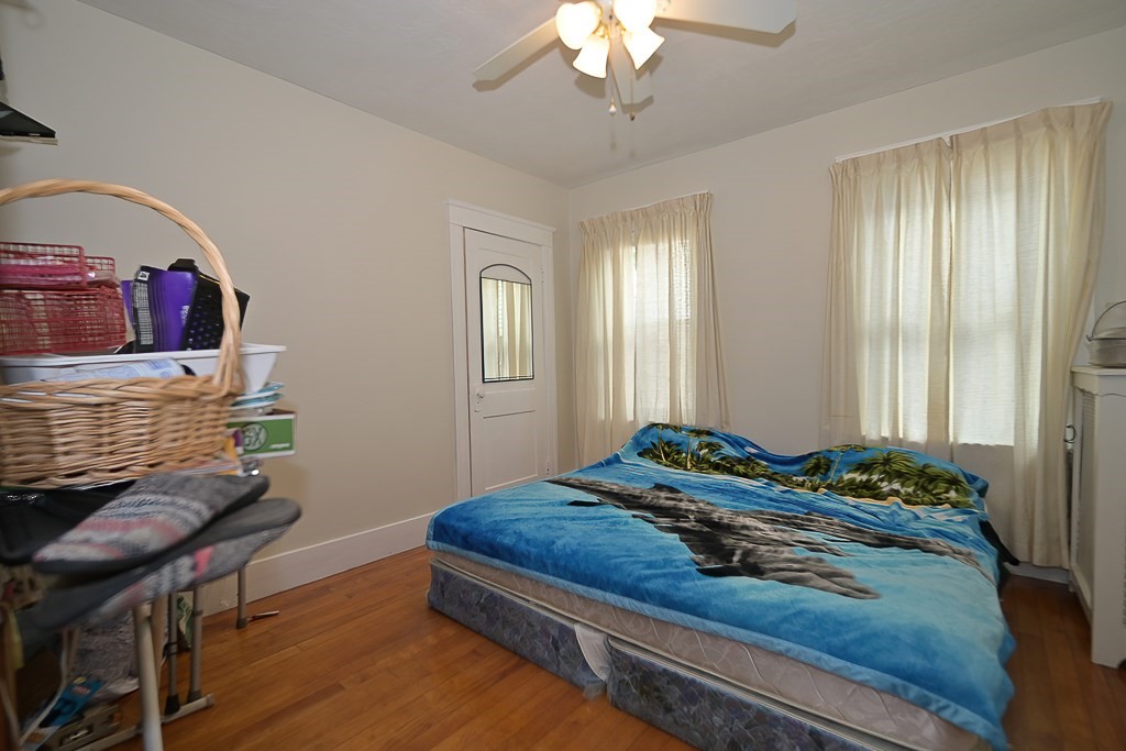 19 Fifth Avenue Worcester, MA 01607 - Photo 3 of 42 a bedroom with a bed and a chandelier