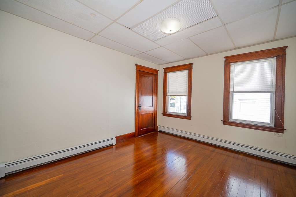 19 Fifth Avenue Worcester, MA 01607 - Photo 31 of 42 an empty room with wooden floor and windows