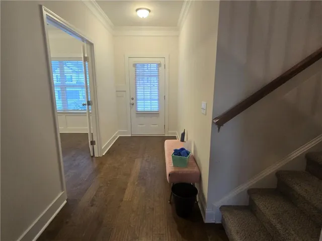 a room with wooden floor and windows