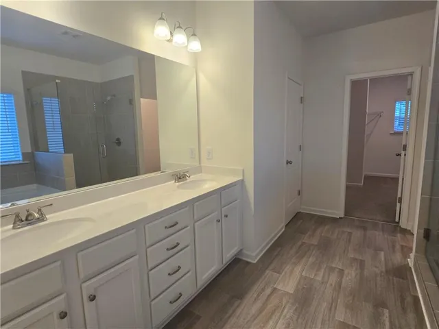 a spacious bathroom with a double vanity sink and a mirror