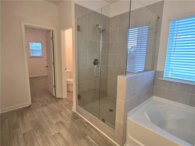 a bathroom with a bathtub and a shower