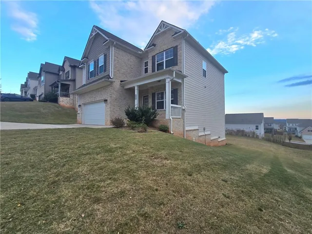 a front view of a house with a yard