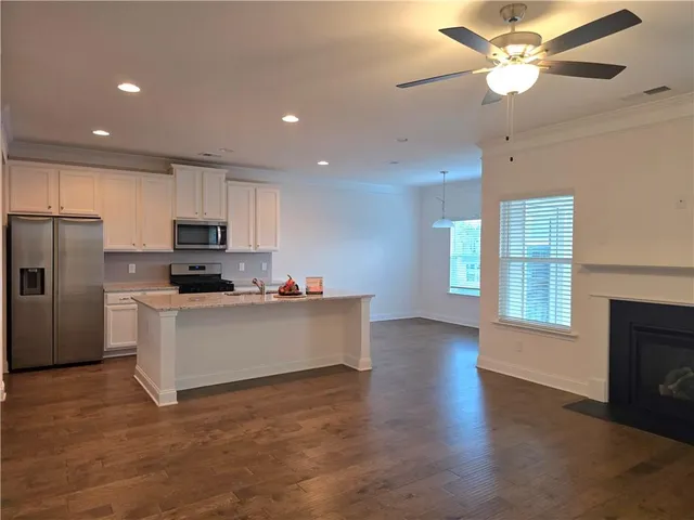 a kitchen with stainless steel appliances a refrigerator sink and cabinets