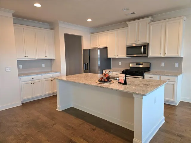 a kitchen with stainless steel appliances a sink stove and refrigerator