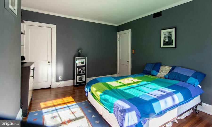 3933 Keswick Road Baltimore, MD 21211 - Photo 11 of 21 a bedroom with a bed and a view of living room