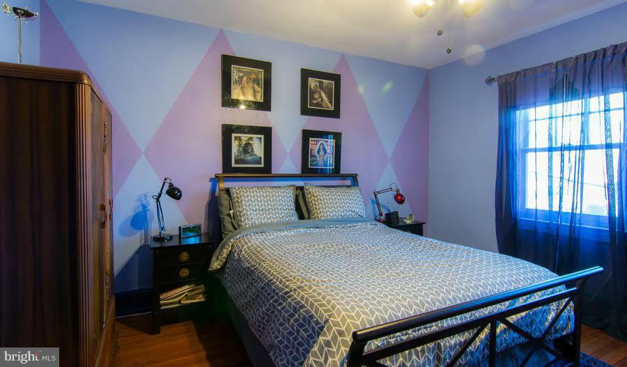 3933 Keswick Road Baltimore, MD 21211 - Photo 12 of 21 a bedroom with a bed and a refrigerator