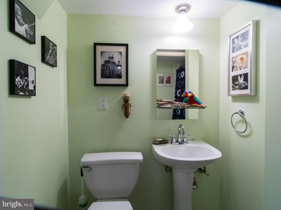 3933 Keswick Road Baltimore, MD 21211 - Photo 16 of 21 a bathroom with a toilet a sink and mirror