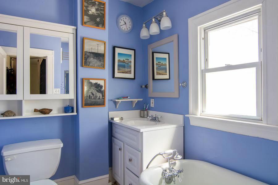 3933 Keswick Road Baltimore, MD 21211 - Photo 18 of 21 a bathroom with a sink toilet and mirror