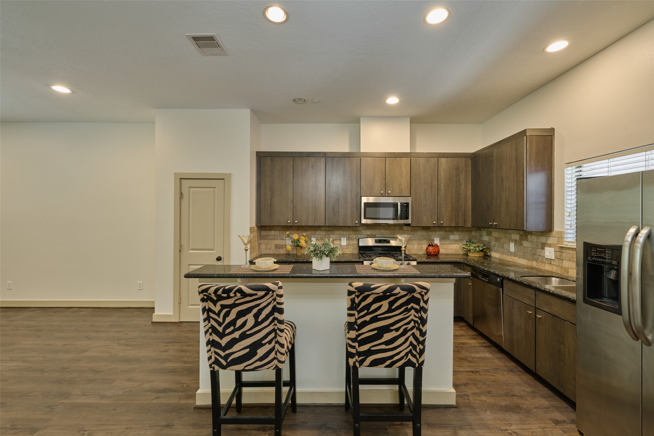 2422 Navigation Boulevard, Unit E Houston, TX 77003 - Photo 15 of 29 a kitchen with kitchen island granite countertop a sink and cabinets