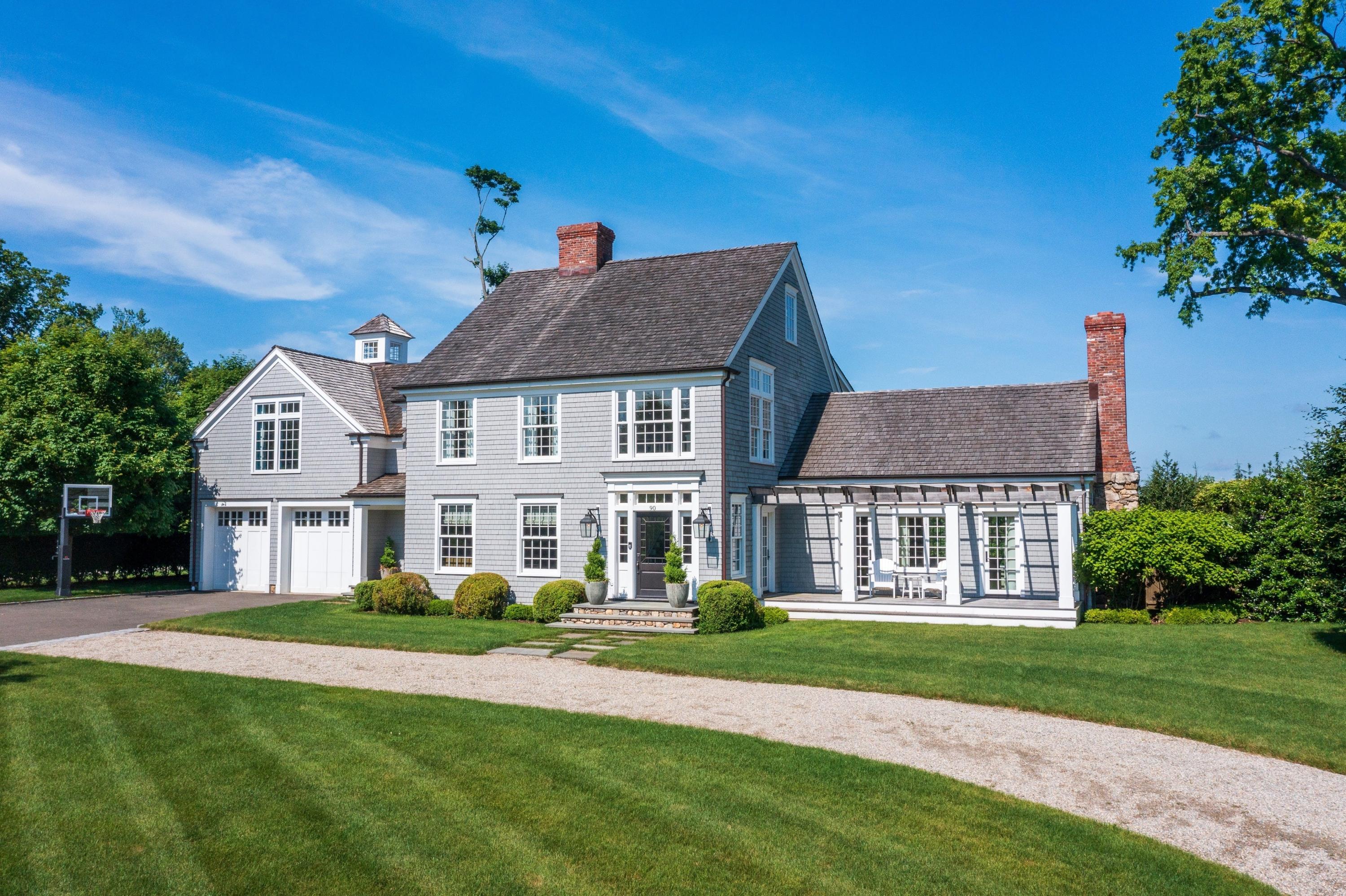 90 Long Neck Point Road Darien, CT 06820 - Photo 1 of 37 a front view of a house with a garden