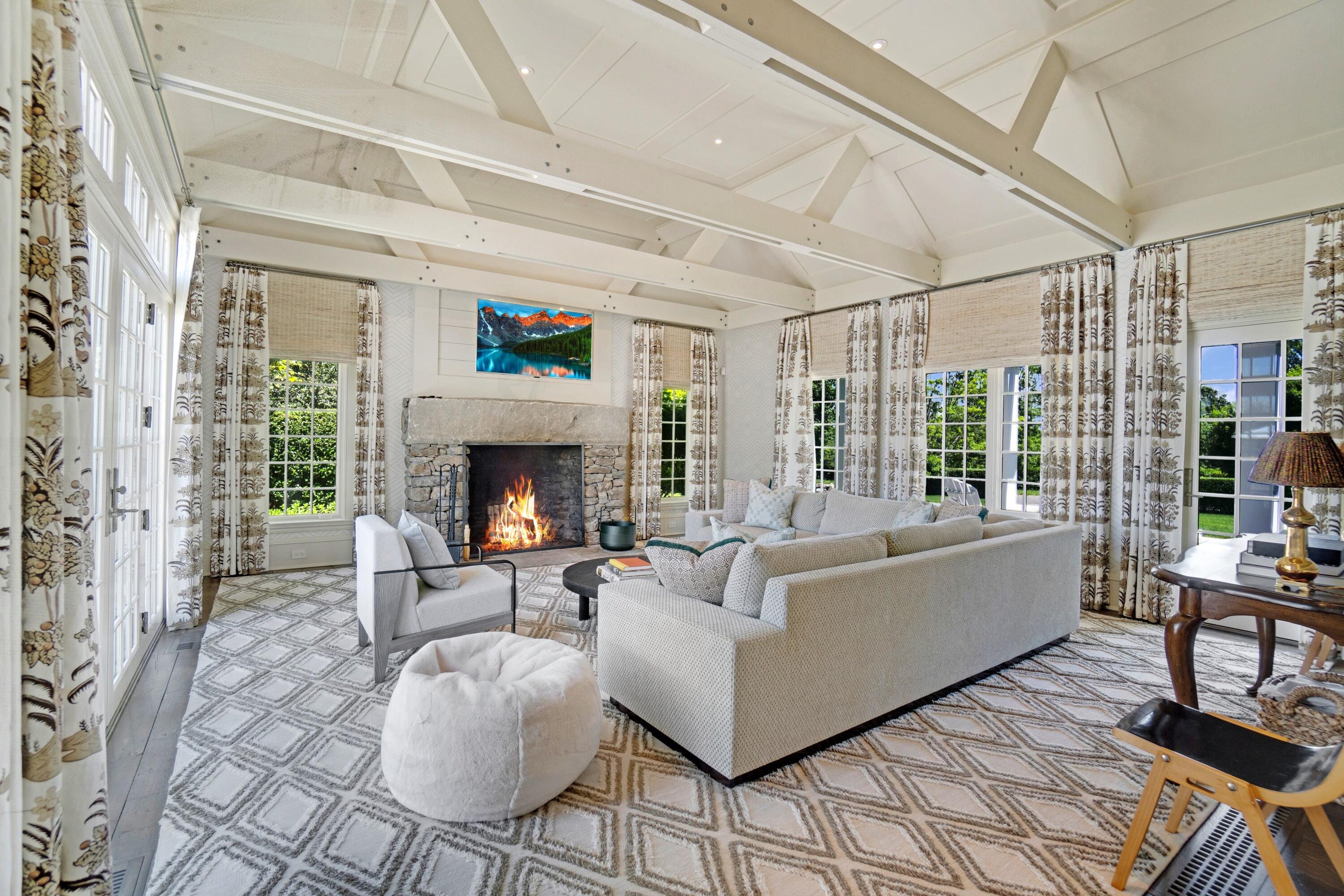 90 Long Neck Point Road Darien, CT 06820 - Photo 11 of 37 a living room with furniture and a fireplace