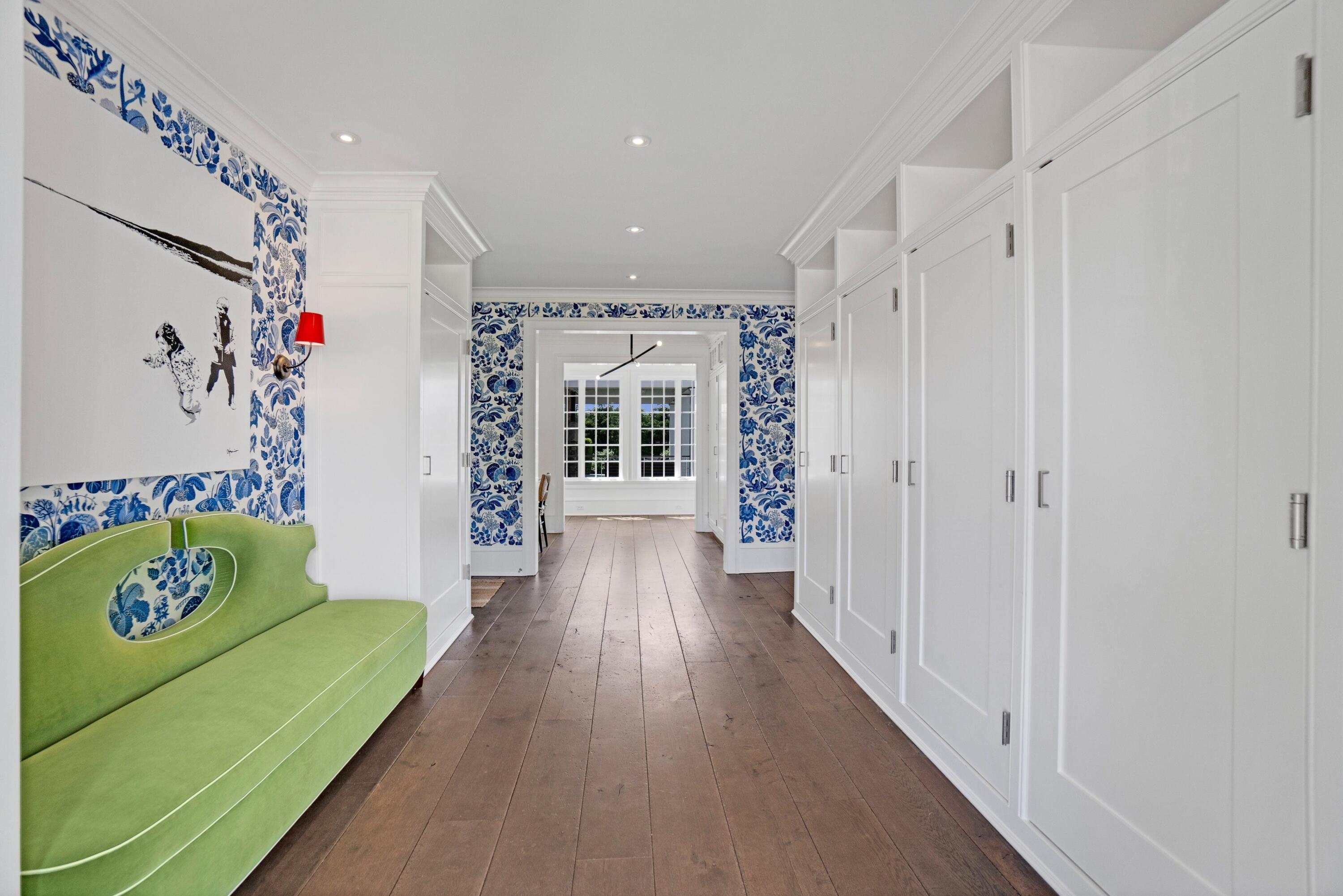 90 Long Neck Point Road Darien, CT 06820 - Photo 17 of 37 a hallway with furniture and a chandelier