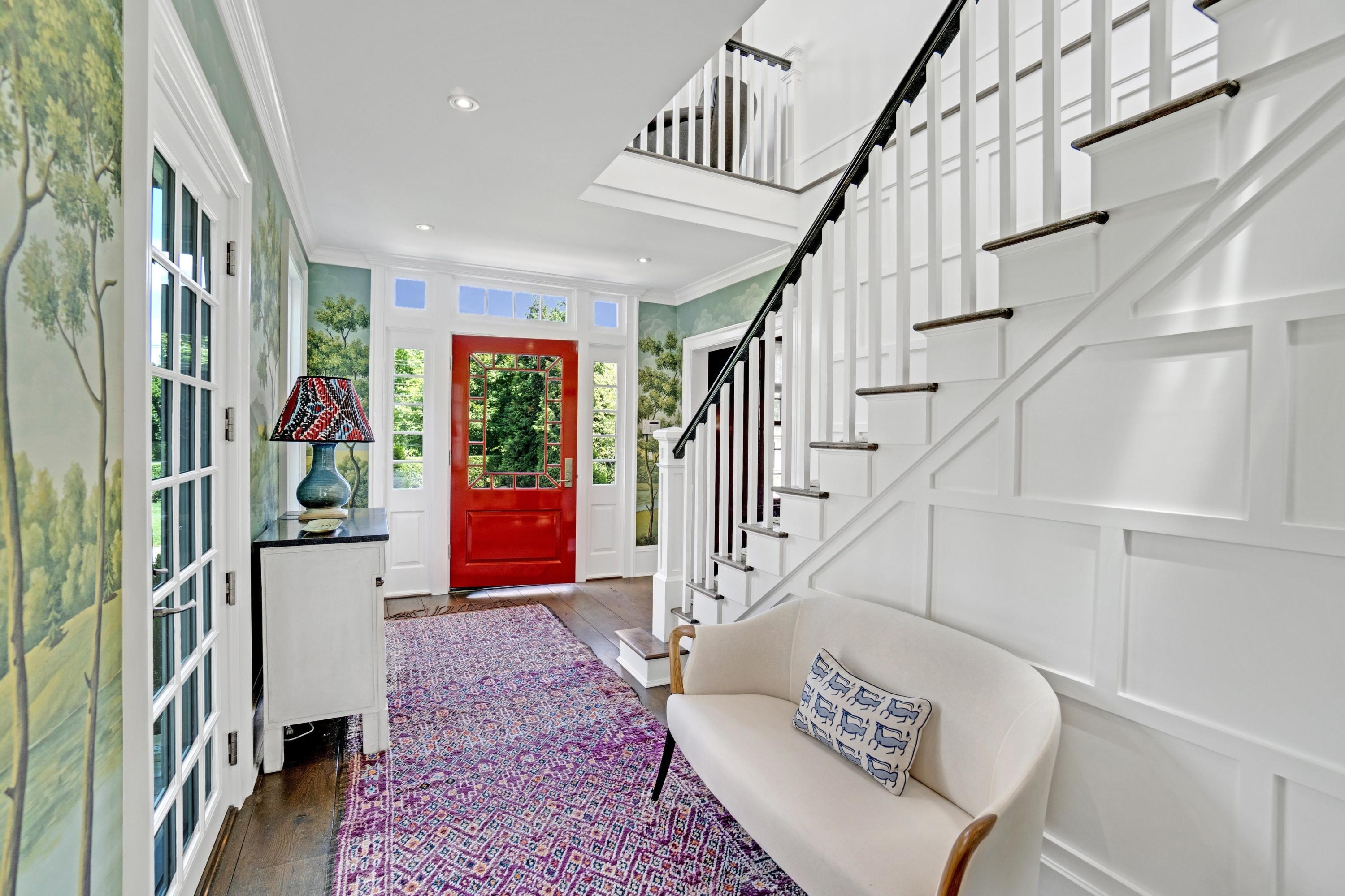 90 Long Neck Point Road Darien, CT 06820 - Photo 18 of 37 a view of staircase with wooden floor and a rug