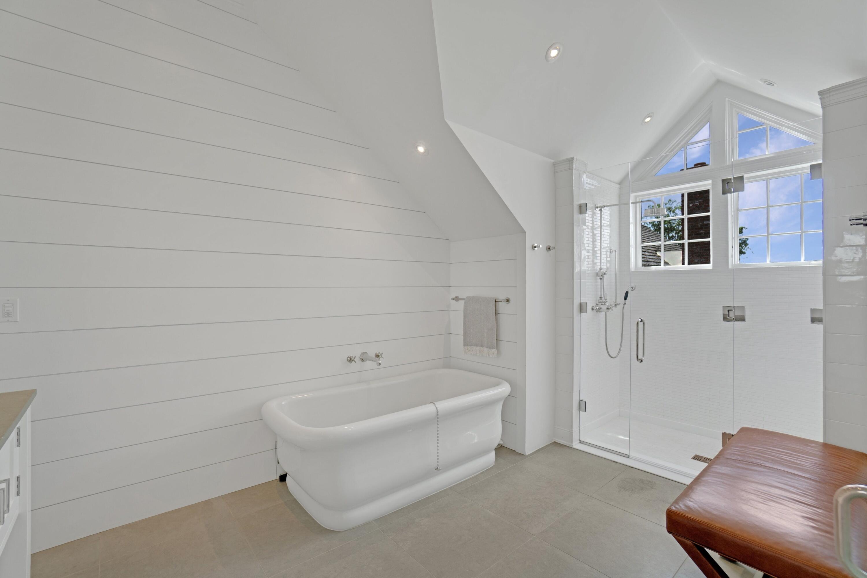 90 Long Neck Point Road Darien, CT 06820 - Photo 24 of 37 a bathroom with a bathtub and shower