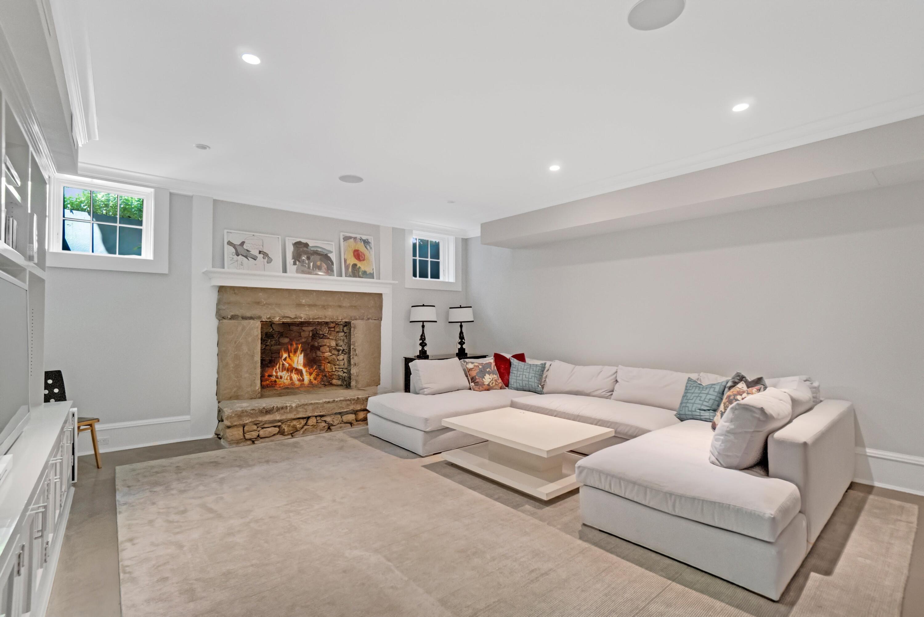 90 Long Neck Point Road Darien, CT 06820 - Photo 27 of 37 a living room with furniture and a fireplace