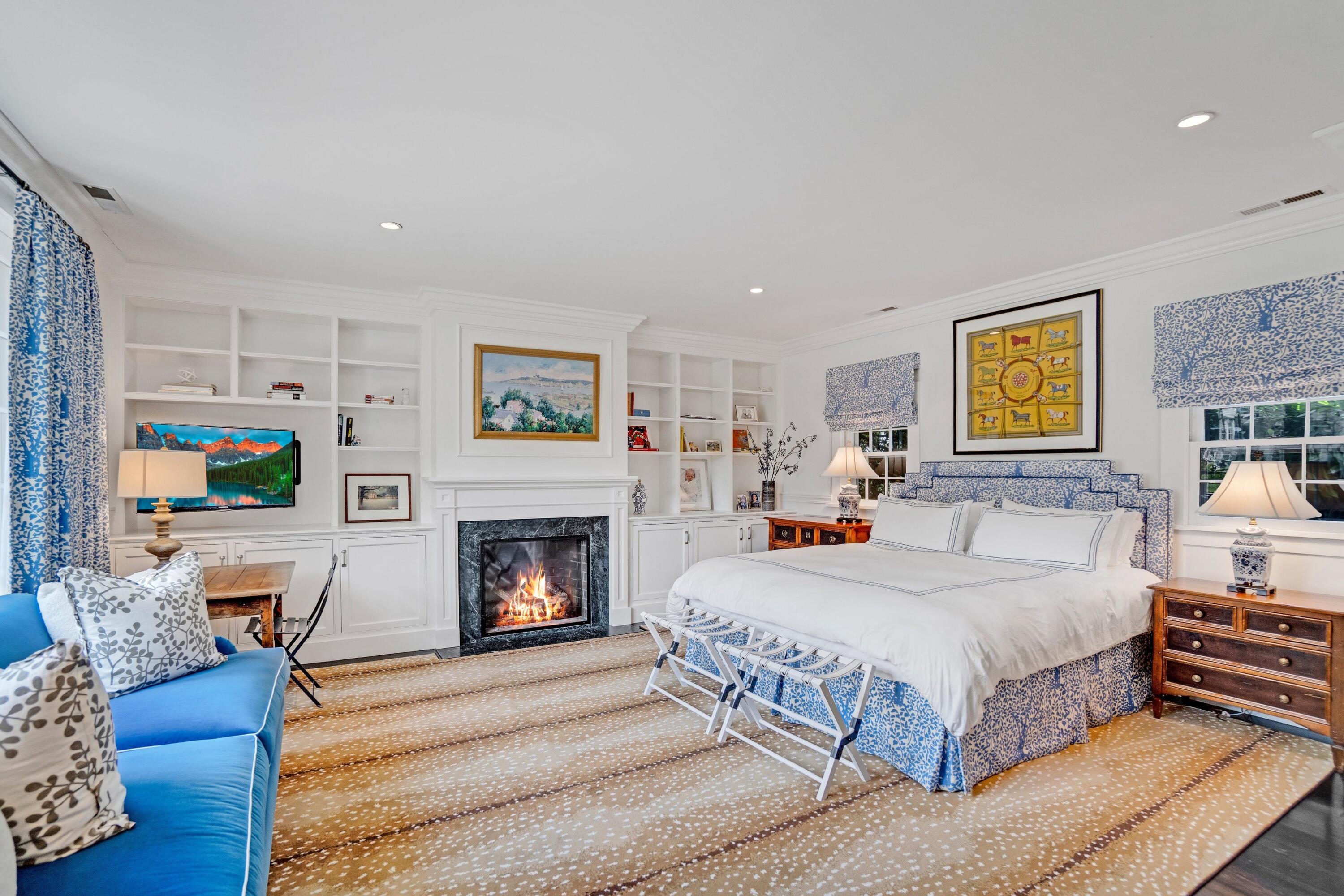 90 Long Neck Point Road Darien, CT 06820 - Photo 31 of 37 a bedroom with a bed and a fireplace