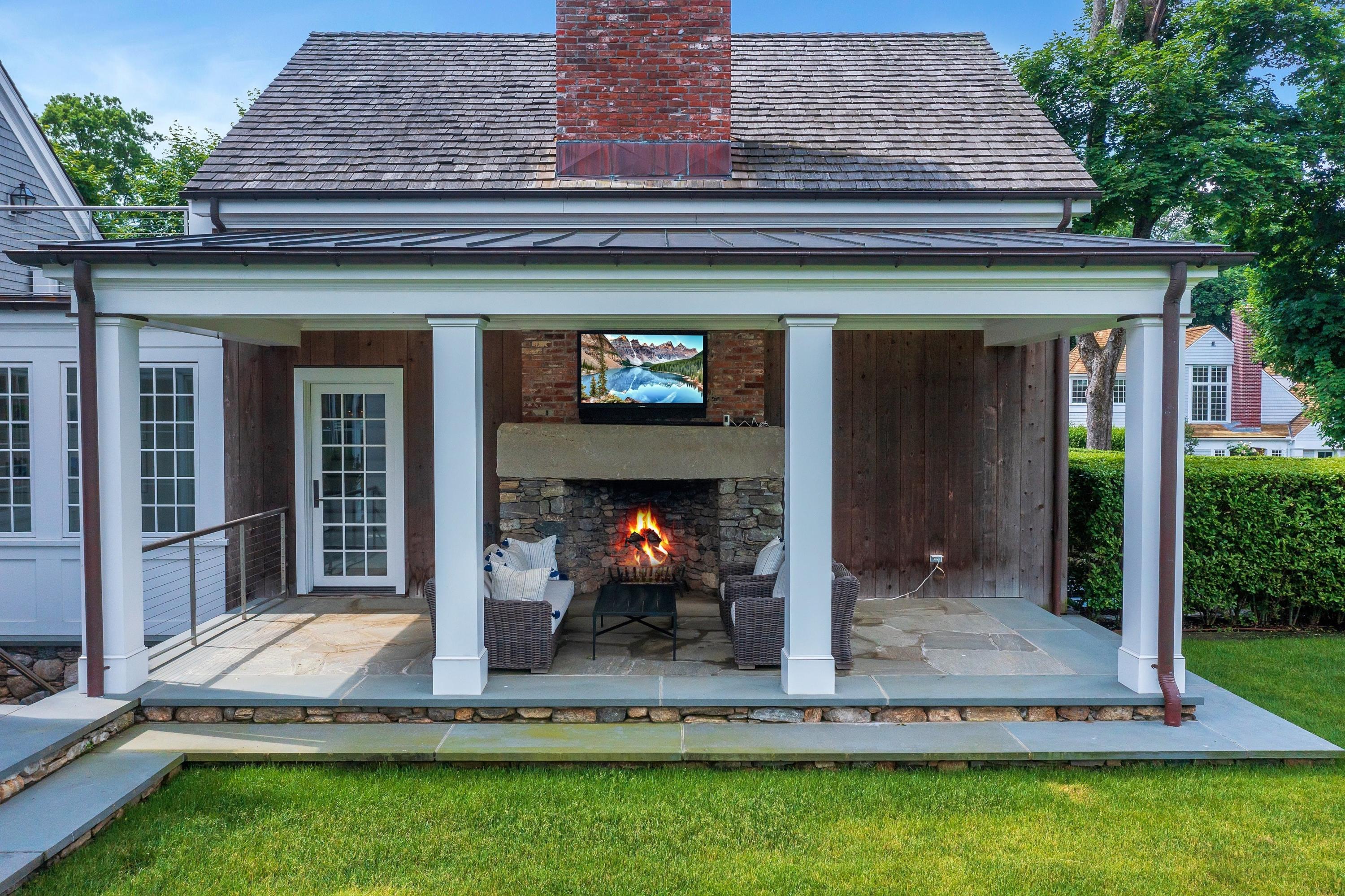 90 Long Neck Point Road Darien, CT 06820 - Photo 7 of 37 front view of a house with a yard