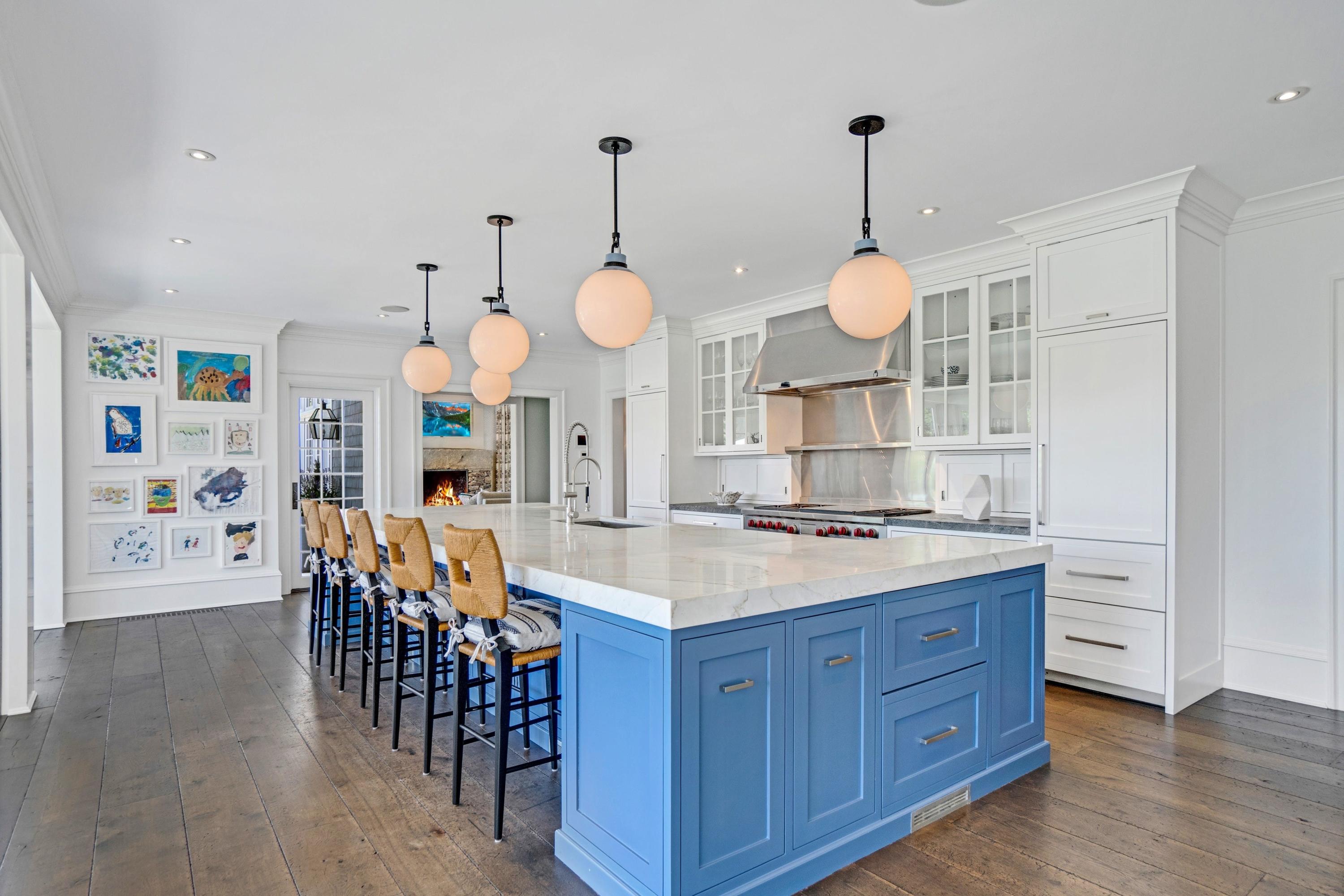 90 Long Neck Point Road Darien, CT 06820 - Photo 9 of 37 a kitchen with stainless steel appliances a stove a sink a dining table and chairs with wooden floor