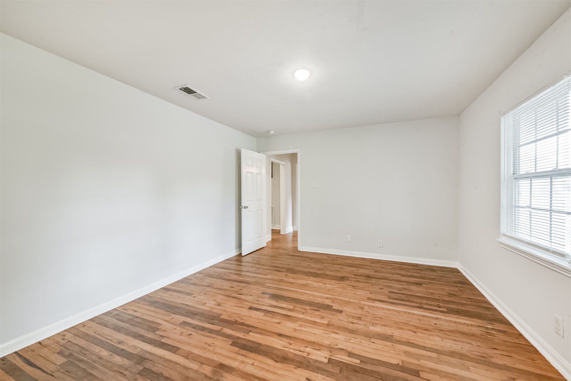 1030 Perkins Drive Bacliff, TX 77518 - Photo 18 of 30 a view of empty room with wooden floor and fan