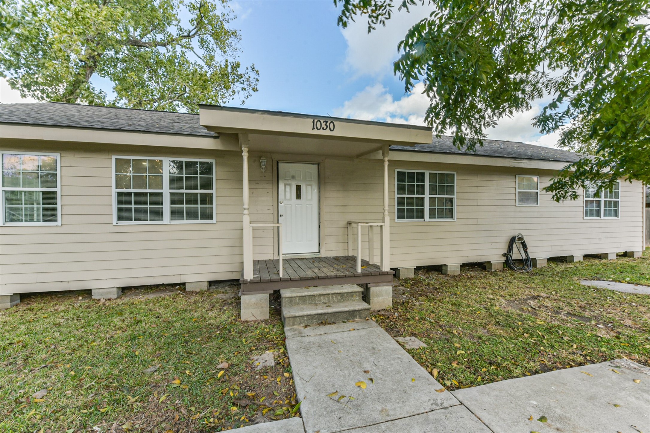 1030 Perkins Drive Bacliff, TX 77518 - Photo 2 of 30 a front view of a house with garden