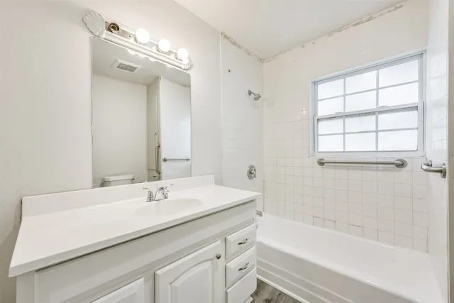 a bathroom with a sink a large mirror and a bathtub