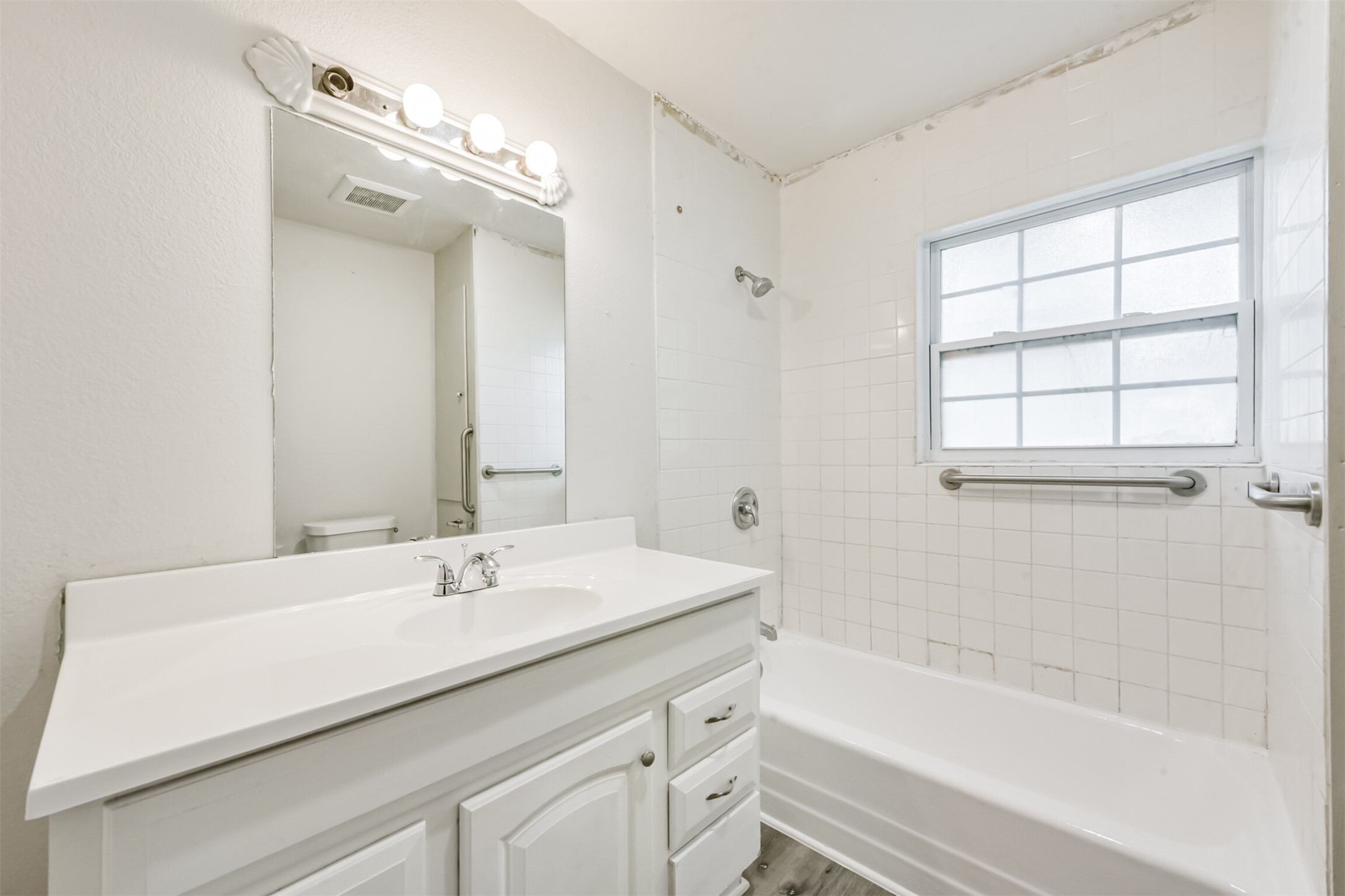 1030 Perkins Drive Bacliff, TX 77518 - Photo 23 of 30 a bathroom with a sink a large mirror and a bathtub