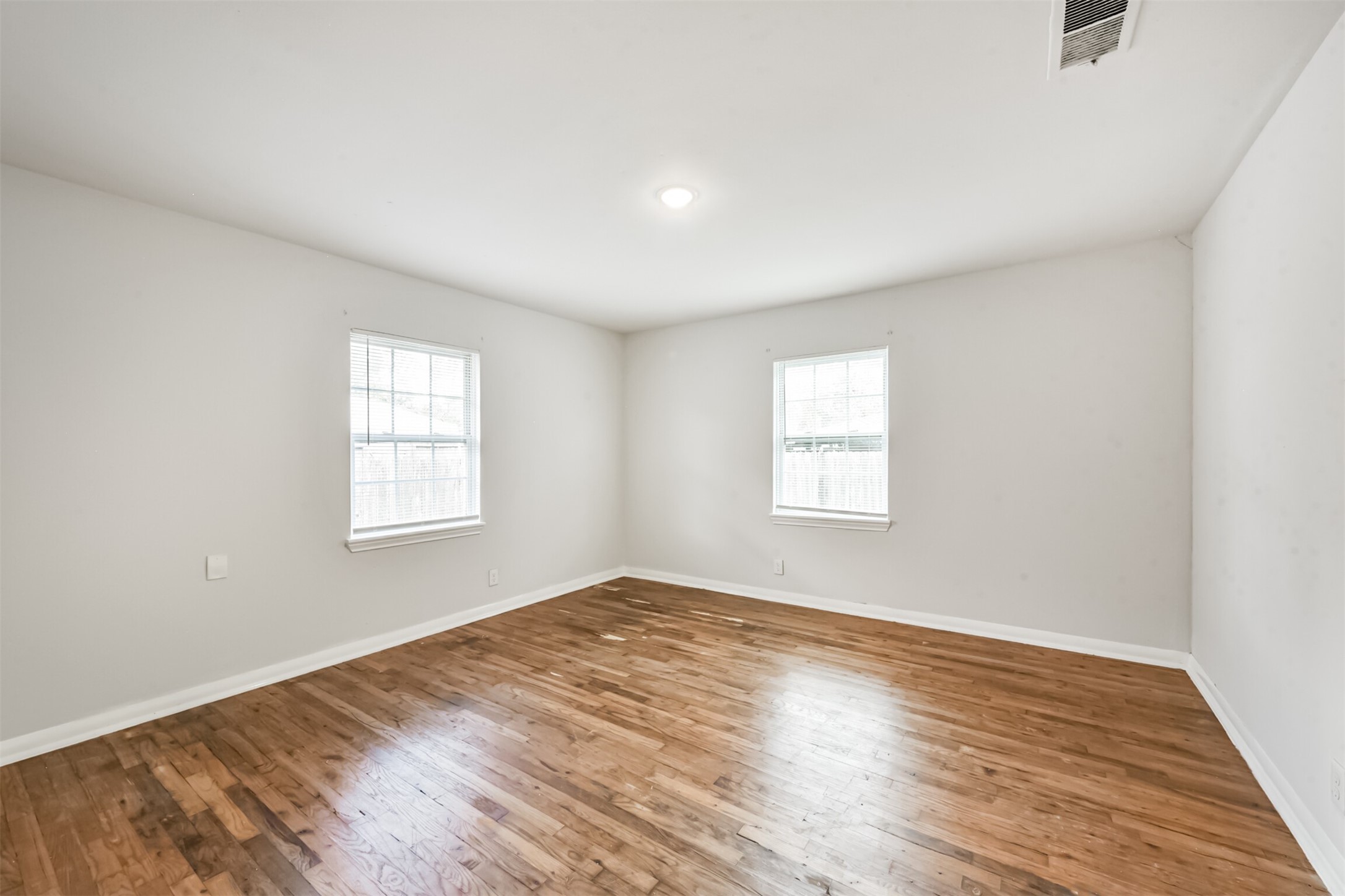1030 Perkins Drive Bacliff, TX 77518 - Photo 24 of 30 an empty room with wooden floor and windows