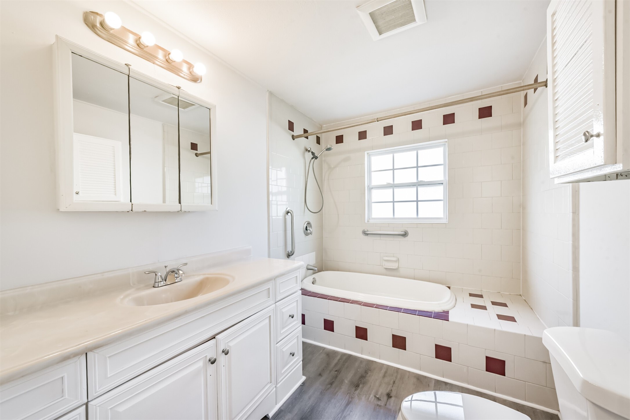 1030 Perkins Drive Bacliff, TX 77518 - Photo 28 of 30 a bathroom with a double vanity sink a mirror and a bathtub