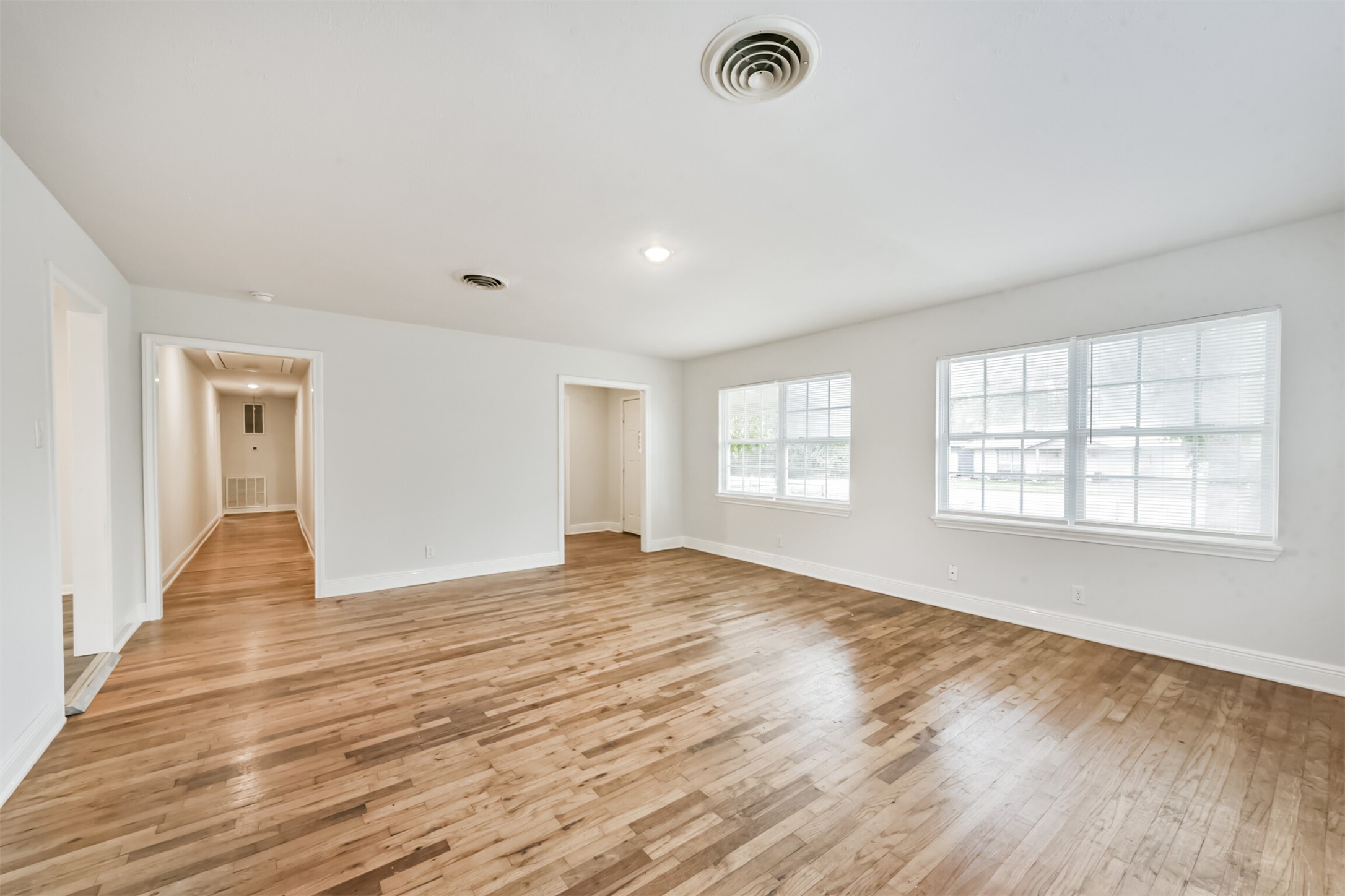 1030 Perkins Drive Bacliff, TX 77518 - Photo 6 of 30 a view of an empty room with wooden floor and a window