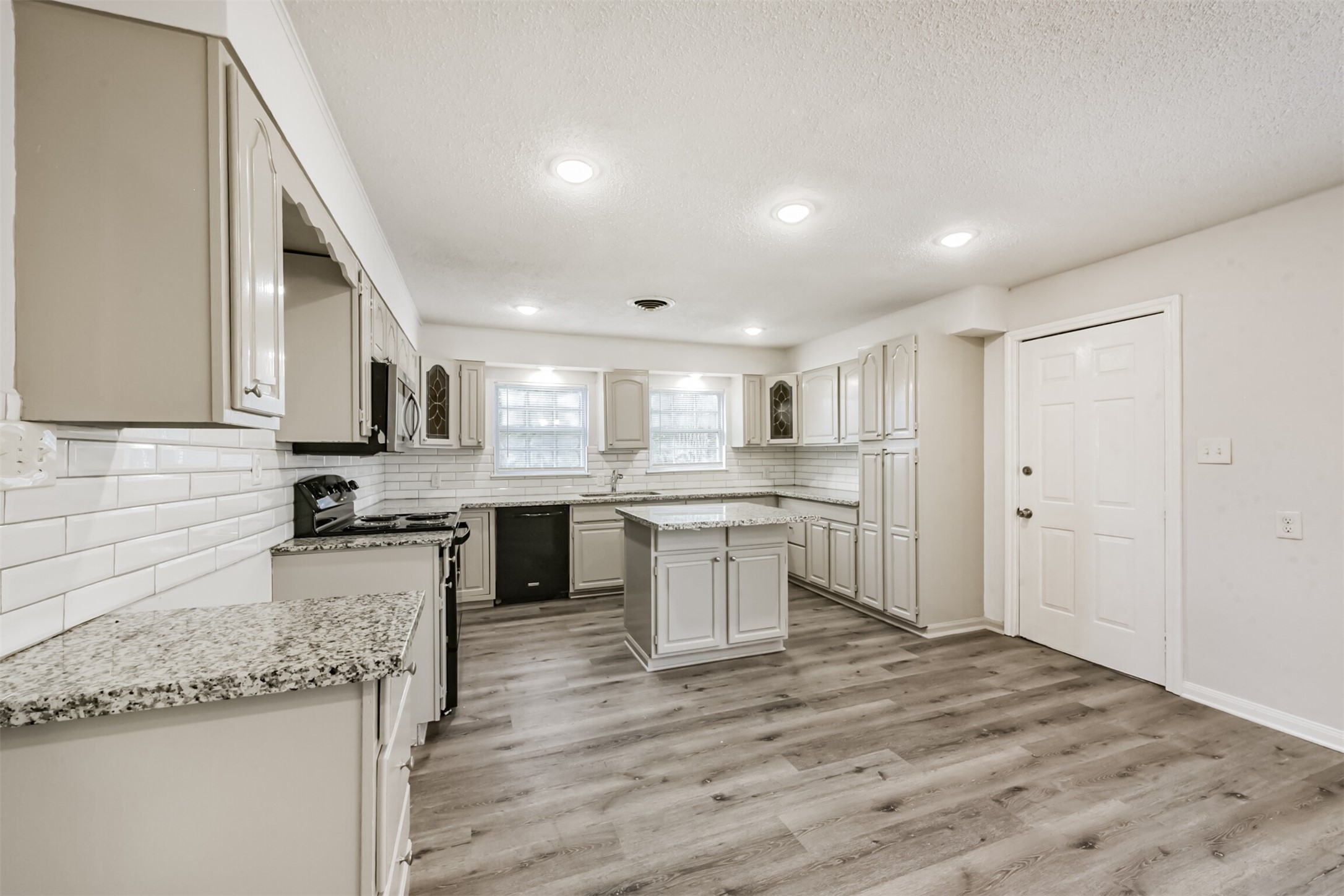 1030 Perkins Drive Bacliff, TX 77518 - Photo 7 of 30 a kitchen with a sink stove top oven and cabinets
