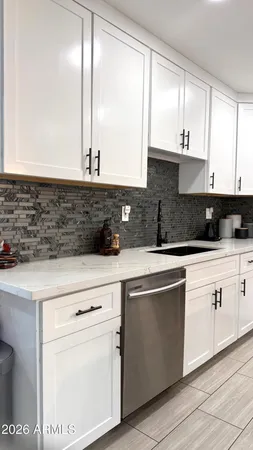 a kitchen with stainless steel appliances granite countertop a sink and a stove