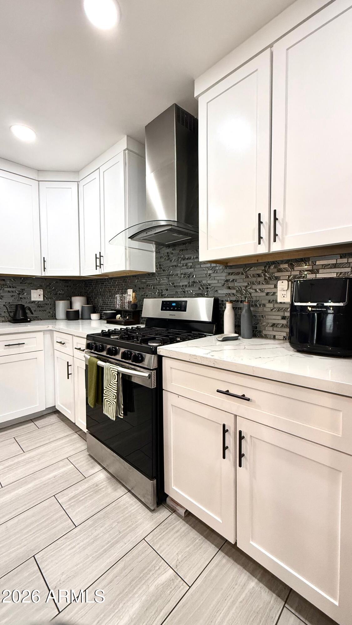 1109 West Indian School Road Phoenix, AZ 85013 - Photo 12 of 38 a kitchen with granite countertop white cabinets and white appliances