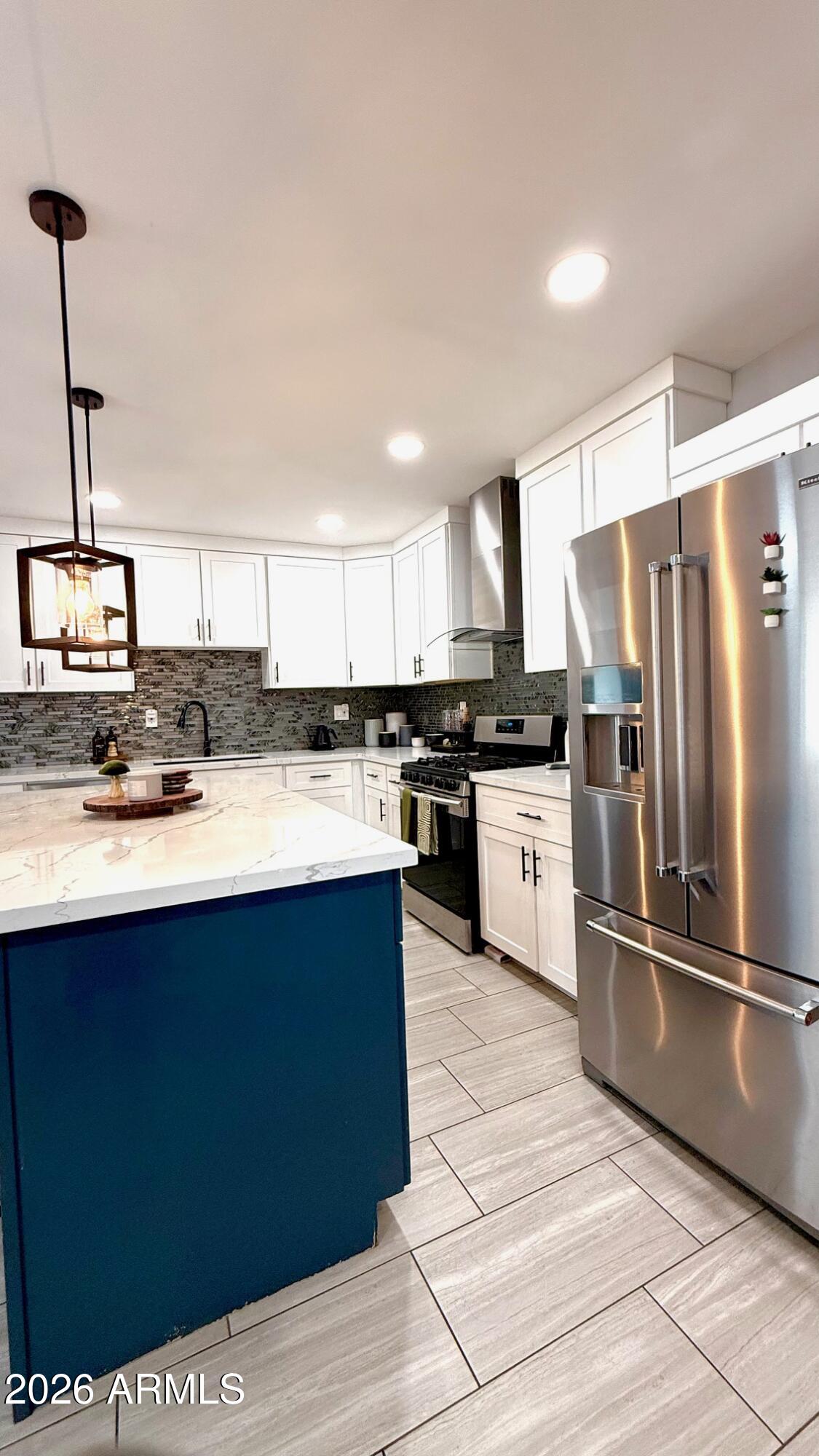 1109 West Indian School Road Phoenix, AZ 85013 - Photo 13 of 38 a kitchen with stainless steel appliances granite countertop a sink a stove a refrigerator and cabinets
