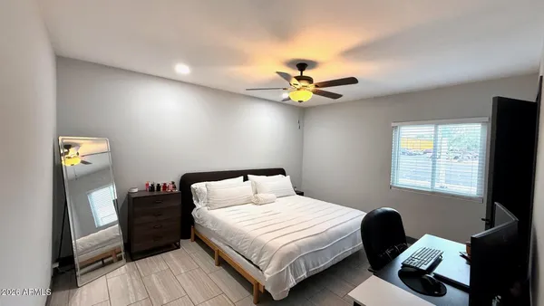 a bedroom with a bed and a flat screen tv