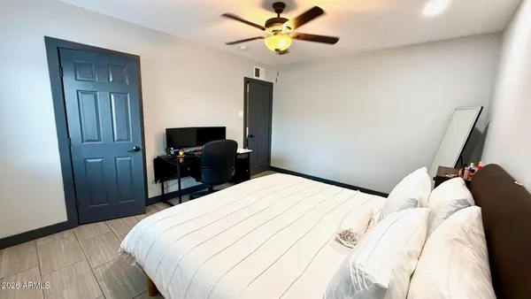 a bedroom with a bed and a chandelier