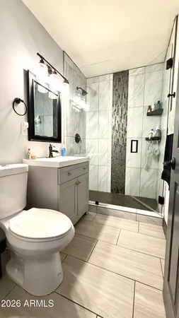 a bathroom with a toilet sink and shower