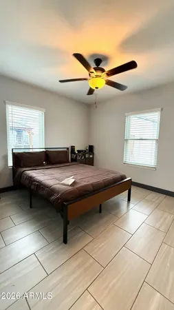 a living room with a bed furniture and a window