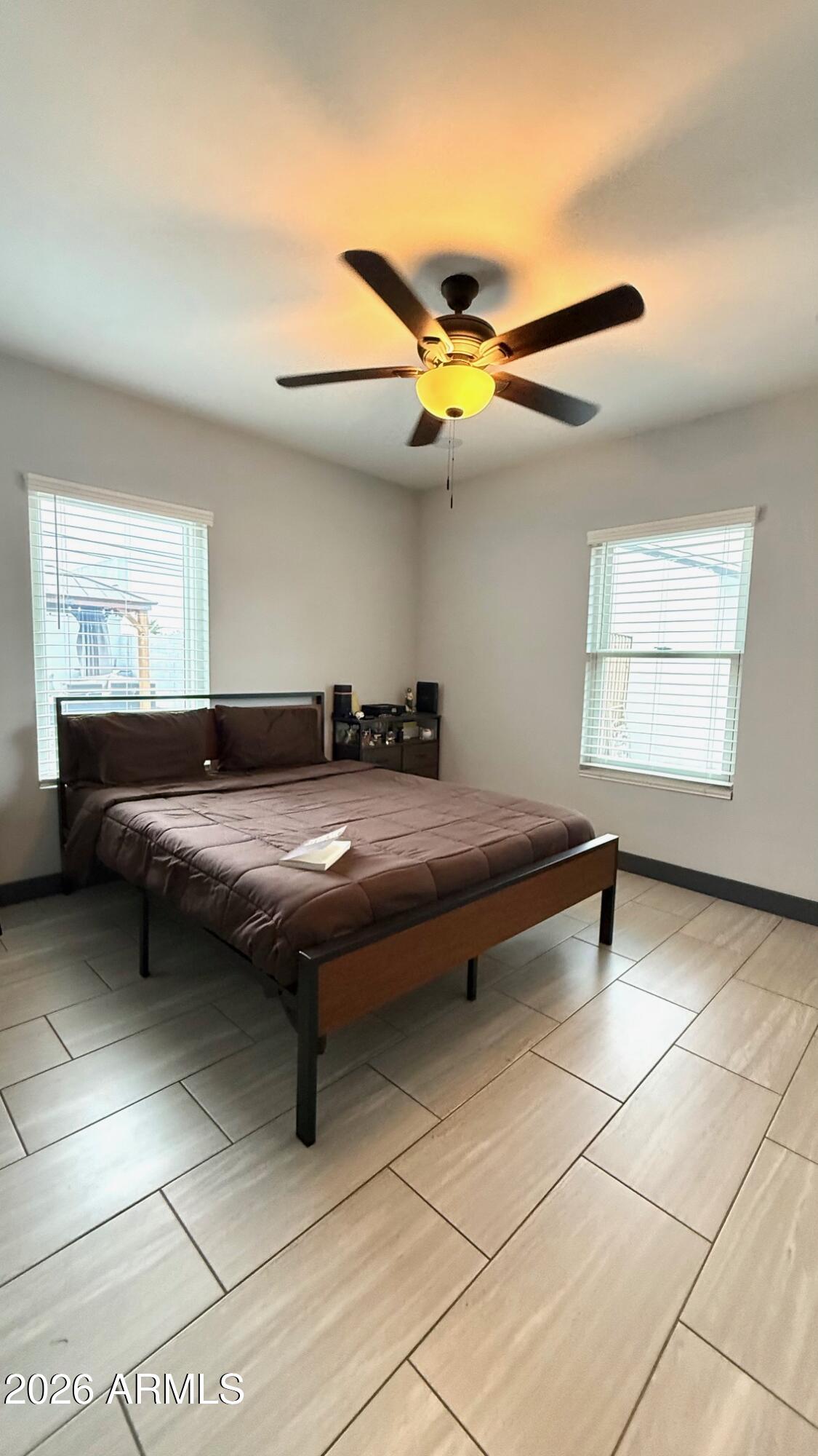 1109 West Indian School Road Phoenix, AZ 85013 - Photo 19 of 38 a living room with a bed furniture and a window