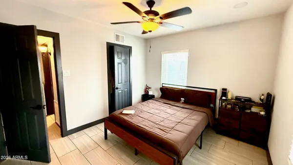 a bedroom with a bed and a chandelier