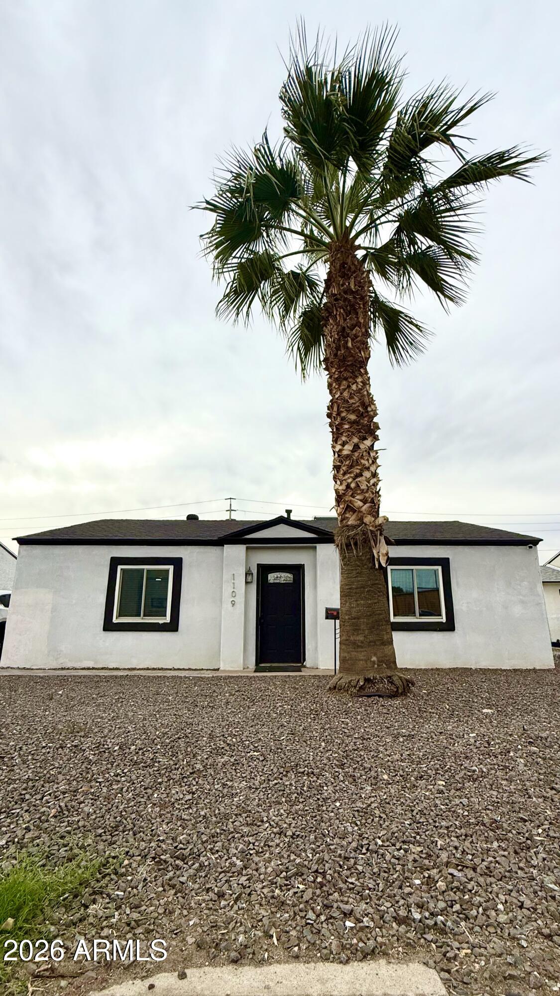 1109 West Indian School Road Phoenix, AZ 85013 - Photo 2 of 38 a picture of a house with a yard and potted plants