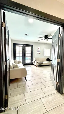 a bedroom with a bed lamp and large window