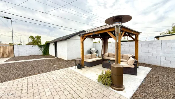 a view of a porch with furniture and a yard