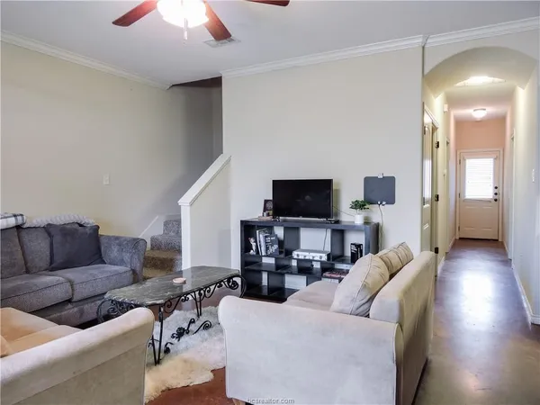 a living room with furniture and a flat screen tv
