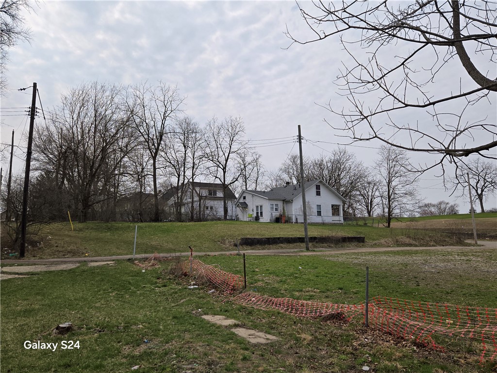 727 West High Street Springfield, OH 45506 - Photo 22 of 29 This expansive lot features a charming home nestled among mature trees, offering a sense of privacy.