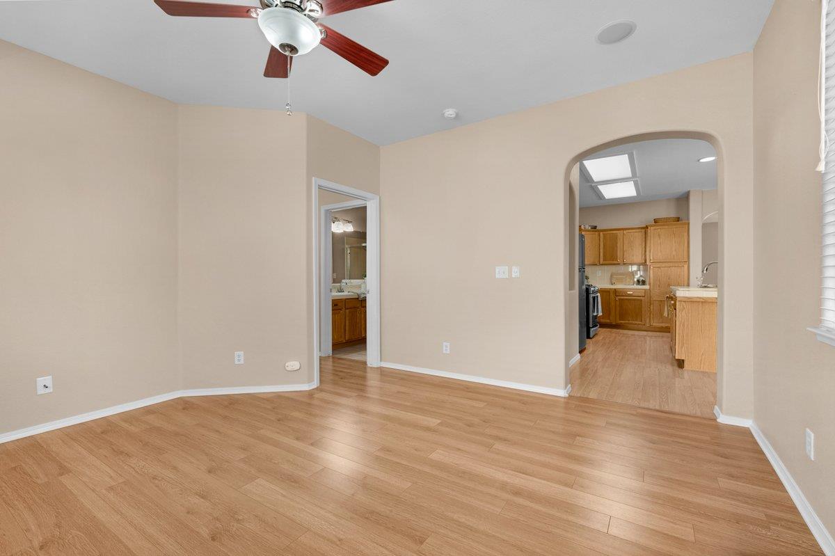 785 West Riviera Lane Clovis, CA 93619 - Photo 16 of 35 an empty room with wooden floor and bathroom view