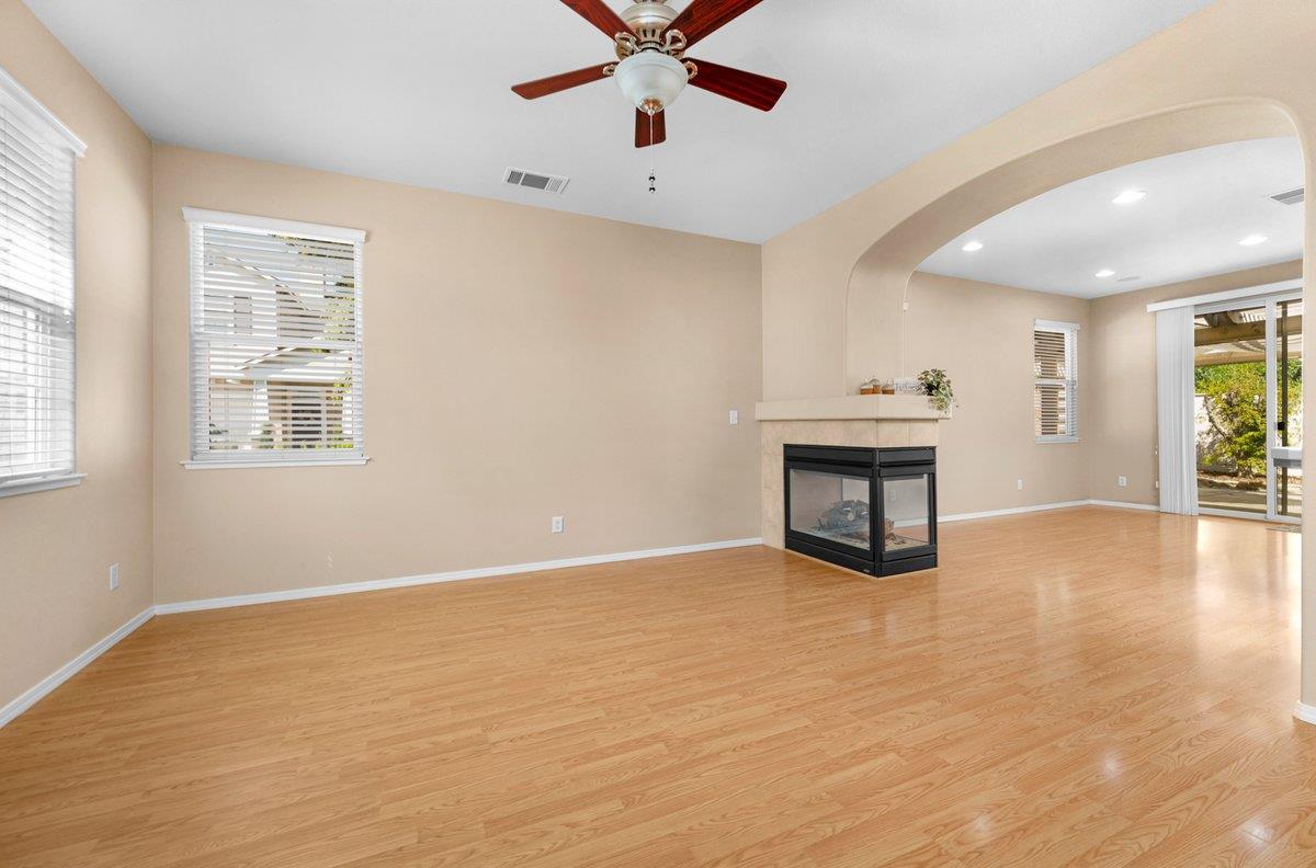 785 West Riviera Lane Clovis, CA 93619 - Photo 6 of 35 a view of an empty room with window and wooden floor