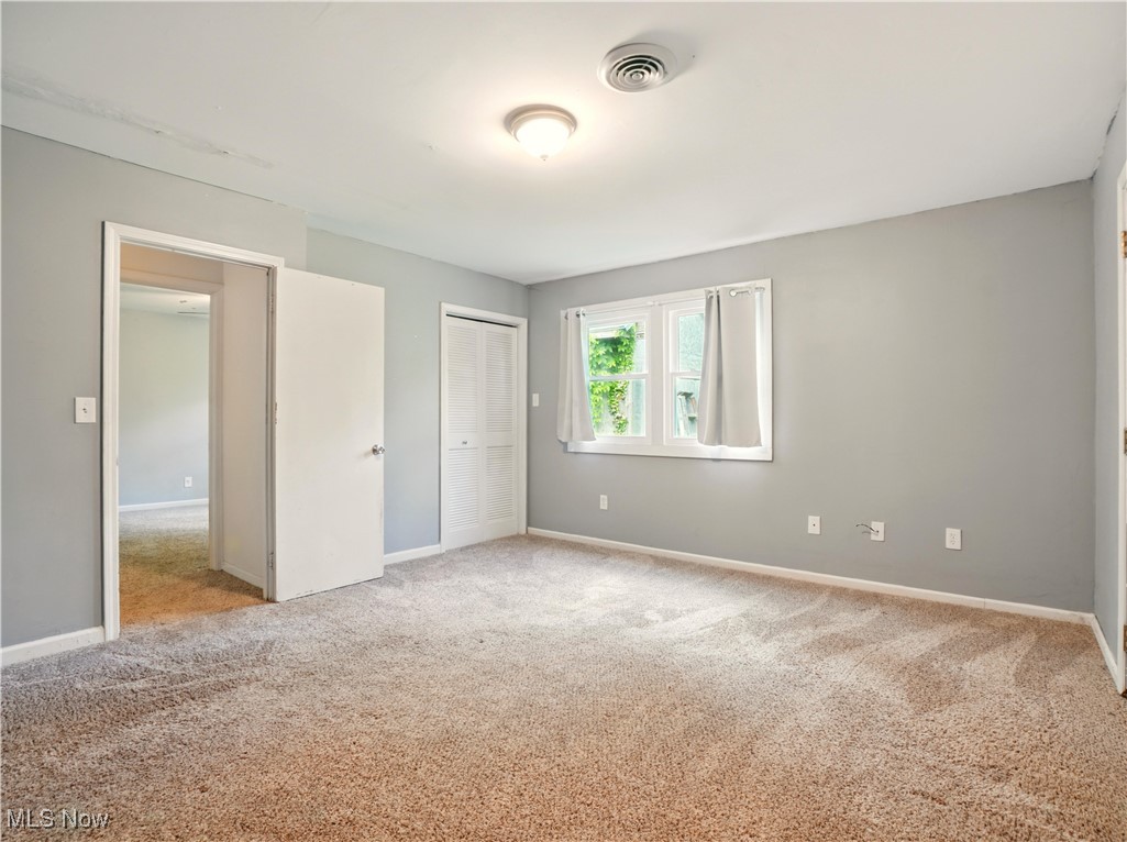 1942 Benjamin Road Madison, OH 44057 - Photo 18 of 29 Unfurnished bedroom with carpet floors, baseboards, and a closet