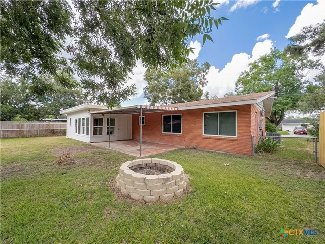 a kitchen with granite countertop a sink stainless steel appliances and cabinets
